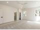Bright bedroom featuring en suite bathroom and walk-in closet, neutral carpet, modern ceiling fan and ample natural light at 1009 Parker St, Raleigh, NC 27607