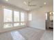 Bright bedroom featuring large windows, neutral carpet, and modern ceiling fan, creating a serene and inviting space at 1009 Parker St, Raleigh, NC 27607