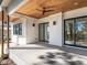 Spacious covered patio featuring a wood-paneled ceiling, ceiling fan, and sliding glass doors, great for relaxation and gatherings at 1009 Parker St, Raleigh, NC 27607