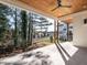 Covered patio with a wood-paneled ceiling, ceiling fan, and a view of the landscaped backyard, perfect for entertaining at 1009 Parker St, Raleigh, NC 27607