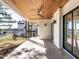 Inviting covered patio with a wood-paneled ceiling, ceiling fan, and sliding glass doors, ideal for indoor-outdoor living at 1009 Parker St, Raleigh, NC 27607