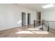 Bright hallway features hardwood floors, skylight, and modern railings at 1009 Parker St, Raleigh, NC 27607