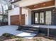 Covered front porch with a wood ceiling and supporting posts, leading to double glass front doors at 1009 Parker St, Raleigh, NC 27607