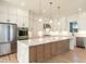 Gourmet kitchen with a large island, stainless steel appliances, and pendant lighting at 1009 Parker St, Raleigh, NC 27607