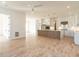 Open-concept kitchen and living area with hardwood floors and modern white cabinets at 1009 Parker St, Raleigh, NC 27607