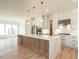 Open-concept kitchen with hardwood floors, a large island, and stainless steel appliances at 1009 Parker St, Raleigh, NC 27607