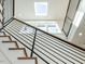 Contemporary staircase design with black metal railings and a skylight to enhance natural lighting at 1009 Parker St, Raleigh, NC 27607