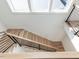 Modern staircase featuring wood steps, black railings, and a skylight at 1009 Parker St, Raleigh, NC 27607