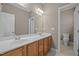 Spacious bathroom with a double vanity, wood cabinetry, and tiled flooring at 1012 Palace Garden Way, Raleigh, NC 27603