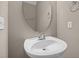 Bathroom featuring pedestal sink, framed oval mirror, and brushed nickel accessories at 1012 Palace Garden Way, Raleigh, NC 27603