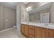 Primary bathroom featuring a double vanity with wood cabinets and a large mirror at 1012 Palace Garden Way, Raleigh, NC 27603