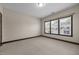 Bright bedroom featuring neutral carpet, white trim, and plenty of natural light from the window at 1012 Palace Garden Way, Raleigh, NC 27603
