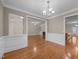 Open-concept dining area with hardwood floors, seamlessly connecting to the living room and kitchen at 1012 Palace Garden Way, Raleigh, NC 27603