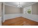 Elegant dining room with wainscoting, chandelier, and natural light, ideal for formal gatherings at 1012 Palace Garden Way, Raleigh, NC 27603