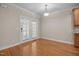 Dining room featuring hardwood floors, neutral paint and double doors with window shutters at 1012 Palace Garden Way, Raleigh, NC 27603
