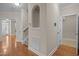 Hallway with hardwood floors and neutral paint leading to multiple rooms at 1012 Palace Garden Way, Raleigh, NC 27603