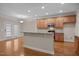 Open kitchen features wood cabinets, granite countertops, and stainless steel appliances at 1012 Palace Garden Way, Raleigh, NC 27603