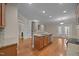 Modern kitchen with granite countertops, stainless steel appliances, and an island, great for cooking and dining at 1012 Palace Garden Way, Raleigh, NC 27603