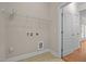 Functional laundry room includes storage shelves and connections for laundry appliances at 1012 Palace Garden Way, Raleigh, NC 27603