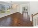 Bright dining room with hardwood floors, wainscoting, and large windows providing ample natural light at 1092 Adams Point Dr, Garner, NC 27529