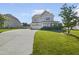 Charming two-story home with a well-manicured front yard, driveway, and attached garage at 1092 Adams Point Dr, Garner, NC 27529