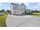 Charming two-story home boasts a well-manicured lawn, long driveway and an attached two-car garage at 1092 Adams Point Dr, Garner, NC 27529