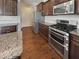 Modern kitchen featuring stainless steel appliances, granite countertops, and ample cabinet space at 1092 Adams Point Dr, Garner, NC 27529