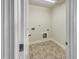 Efficient laundry room features tile floors, utility connections, and neutral wall paint at 1092 Adams Point Dr, Garner, NC 27529