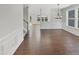 Elegant living room with hardwood floors and wainscoting detail bathed in natural light at 1092 Adams Point Dr, Garner, NC 27529
