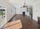 Spacious living room with hardwood floors, a fireplace, ceiling fan, and sliding doors to the outdoor living space at 1092 Adams Point Dr, Garner, NC 27529