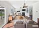 Bright living room with a fireplace, ceiling fan, and sliding doors to the outdoor living space at 1092 Adams Point Dr, Garner, NC 27529