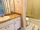 This bathroom includes a tub shower combination, toilet, and vanity with marble countertops at 120 W Front St, Oxford, NC 27565