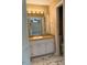 Bathroom featuring marble tile floors, double mirror, and white cabinetry with marble countertops at 120 W Front St, Oxford, NC 27565