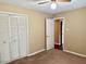 Carpeted bedroom featuring a closet and access to the hallway at 120 W Front St, Oxford, NC 27565