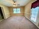 Spacious carpeted bedroom featuring natural light from a large window and door at 120 W Front St, Oxford, NC 27565