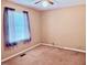 Bright bedroom featuring a window with curtain, neutral paint and carpet, plus ceiling fan at 120 W Front St, Oxford, NC 27565