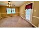 Spacious carpeted bedroom featuring natural light from a large window and door at 120 W Front St, Oxford, NC 27565
