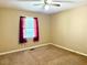 Carpeted bedroom featuring natural light from a window and ceiling fan at 120 W Front St, Oxford, NC 27565