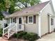 Charming home featuring a classic facade with a brick entryway and well-manicured landscaping at 120 W Front St, Oxford, NC 27565