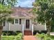 Inviting home exterior with a brick pathway and decorative landscaping enhancing curb appeal at 120 W Front St, Oxford, NC 27565