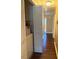 Hallway with a washer, white doors, and hardwood floors in a home's interior at 120 W Front St, Oxford, NC 27565