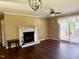 Bright living room featuring fireplace, hardwood floors, and sliding glass doors at 120 W Front St, Oxford, NC 27565