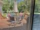 View of a patio set outside through window blinds, looking out to a backyard at 120 W Front St, Oxford, NC 27565