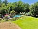 Spacious backyard including a pool, landscaping, trees, and grass in the home's exterior at 120 W Front St, Oxford, NC 27565