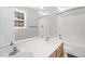 Bright bathroom features double sinks, a window and a shower-tub combo at 1201 Teakwood Ct, Sanford, NC 27330