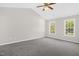 Spacious bedroom with vaulted ceiling, ceiling fan and two sun-filled windows at 1201 Teakwood Ct, Sanford, NC 27330