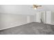 Upstairs bedroom has neutral paint, carpet and a walk-in closet at 1201 Teakwood Ct, Sanford, NC 27330