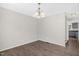 Open dining area with hardwood floors adjacent to kitchen; chandelier overhead at 1201 Teakwood Ct, Sanford, NC 27330