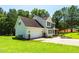 Two-story home with an attached two-car garage and a well-maintained lawn in a suburban setting at 1201 Teakwood Ct, Sanford, NC 27330