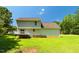 Exterior view of the back of the home with a large yard and deck at 1201 Teakwood Ct, Sanford, NC 27330